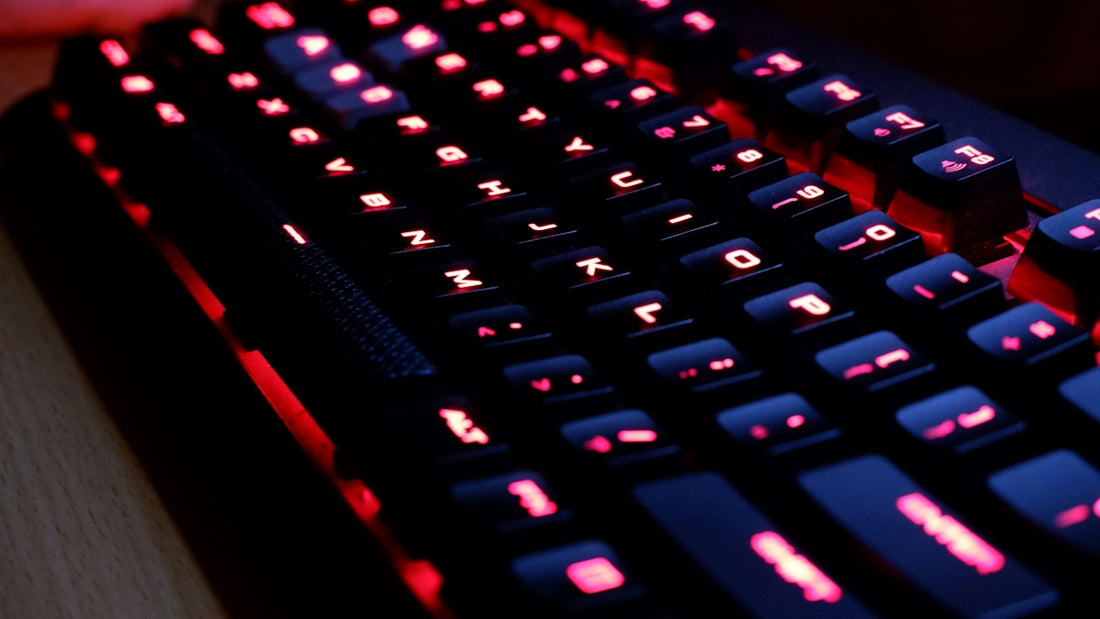 a close up of a keyboard with red lights