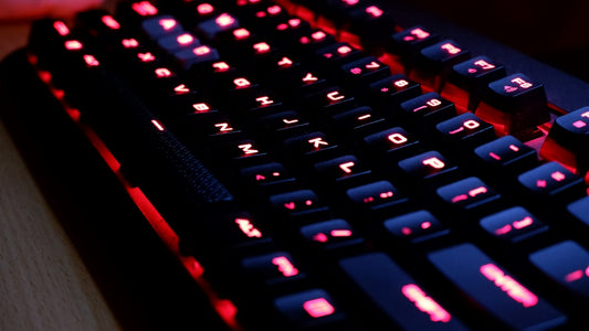 a close up of a keyboard with red lights