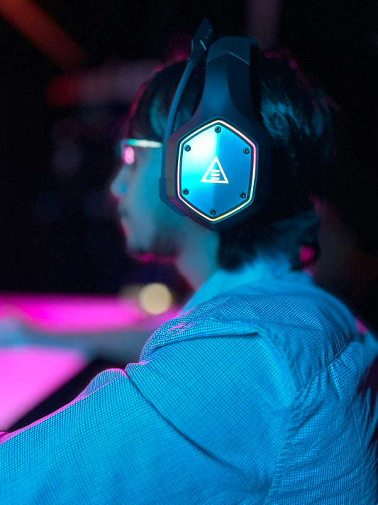 a man wearing a pair of headphones in a dark room