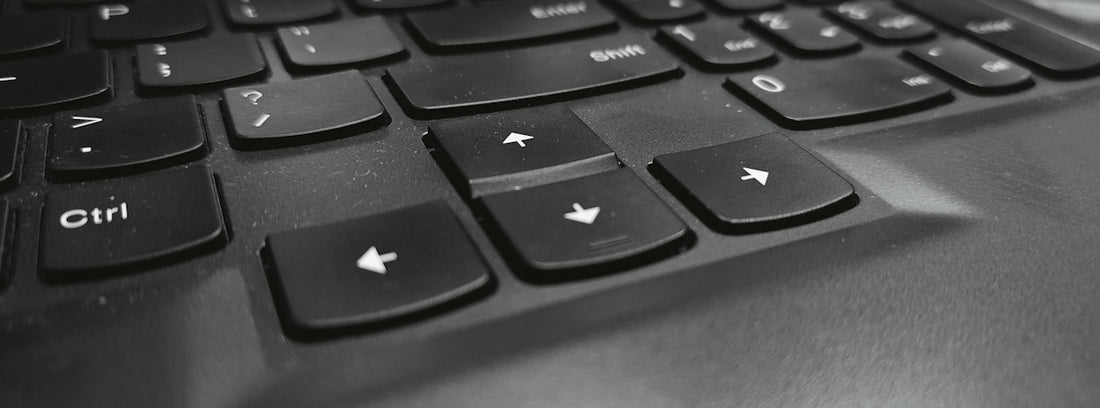 A black and white photo of a laptop keyboard