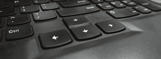 A black and white photo of a laptop keyboard